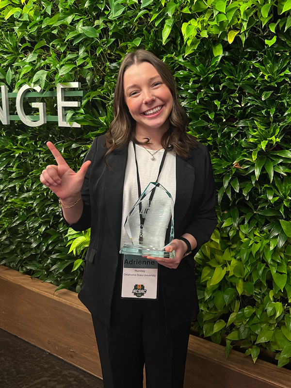 Adrienne Huntley posing with her award from the National Collegiate Sports Analytics Championship.