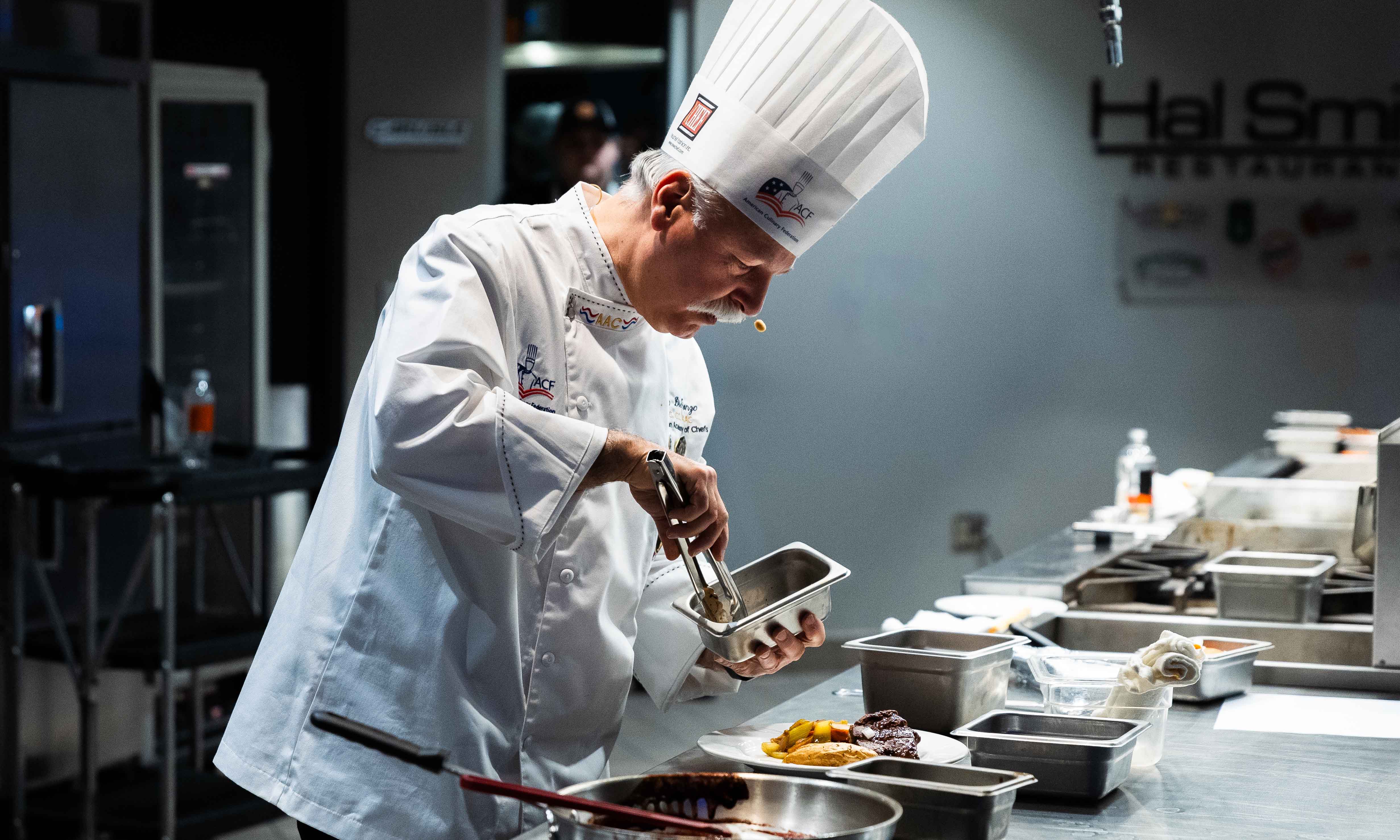 Chef Americo DiFronzo preparing food.