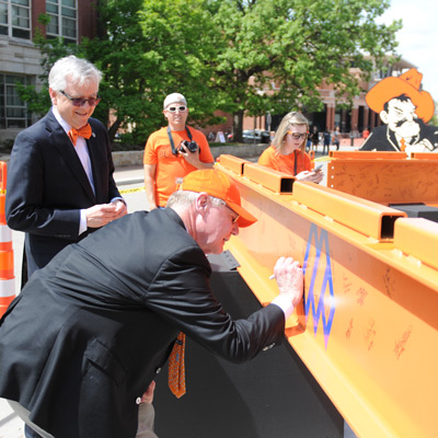 Dean Eastman and Burns Hargis signing the beam