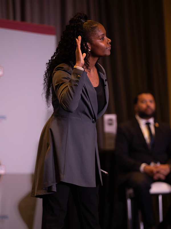 Aundrea Payne speaking on stage at an event