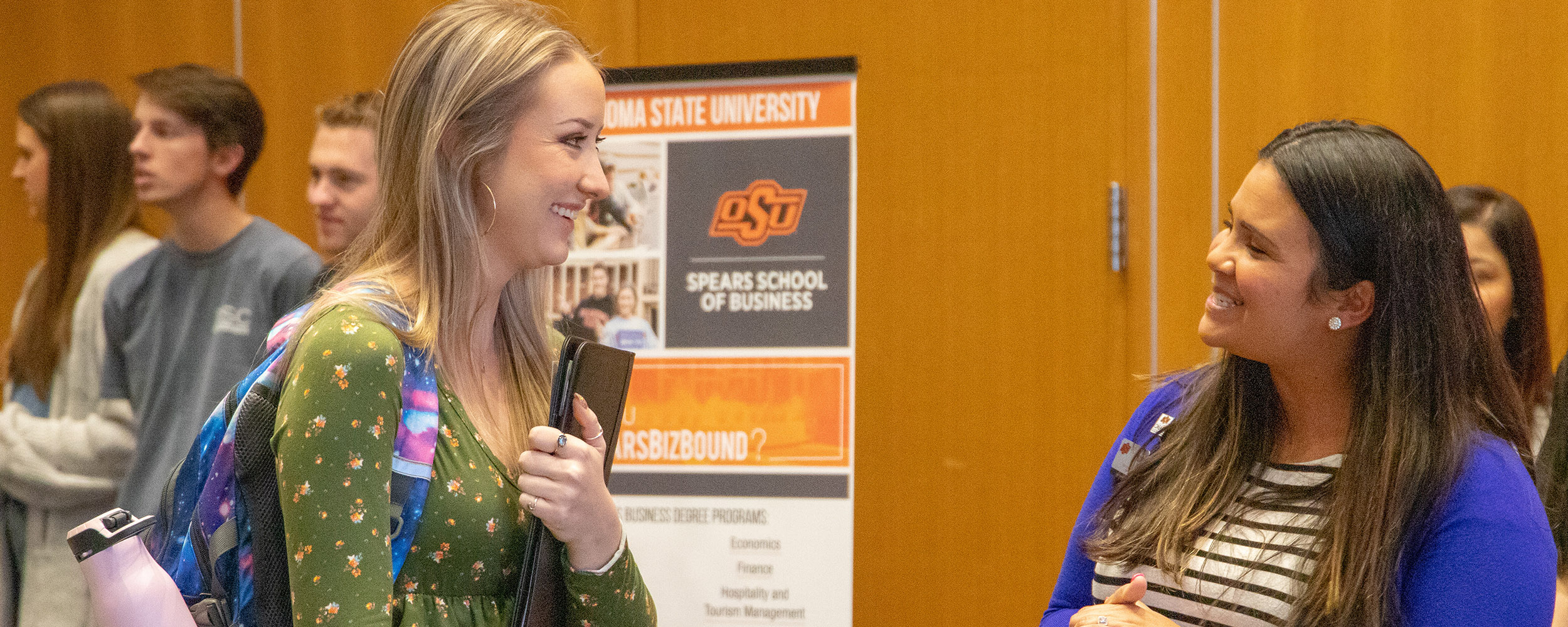 A female student networking with a recruiter. A female student networking with a recruiter.