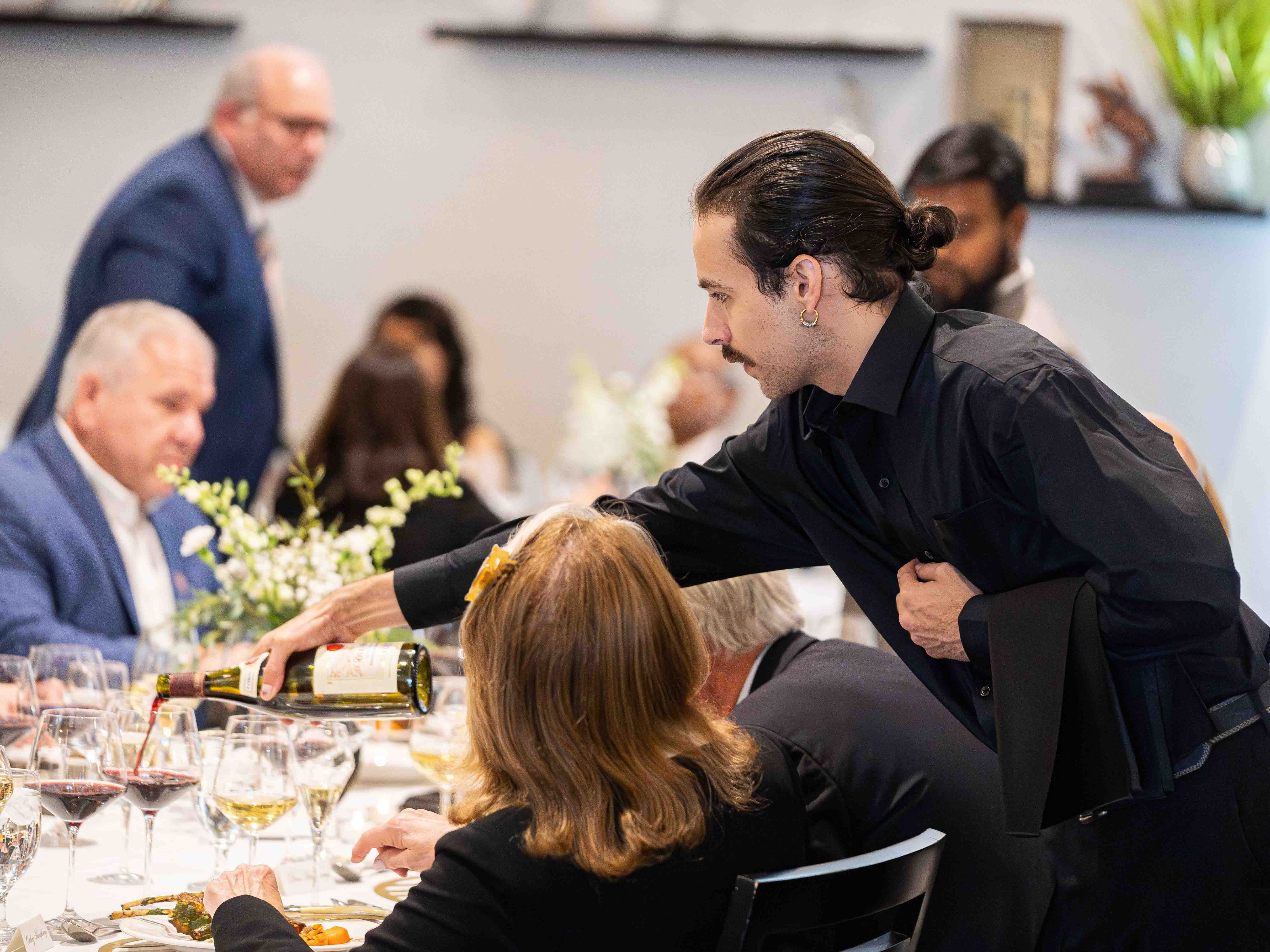 Student serving wine