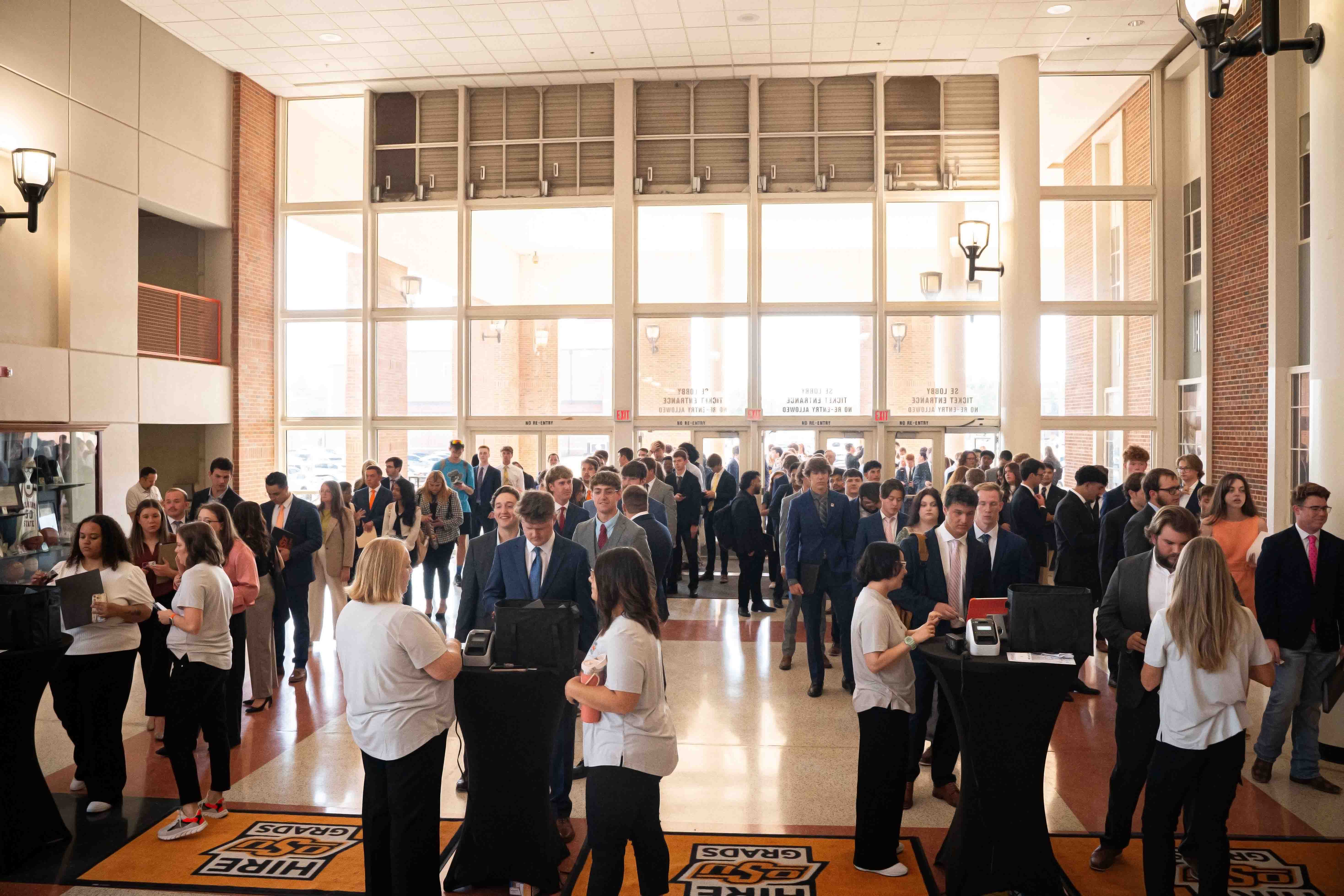 Students lined up to check in for the career fair. Everyone wearing business professional clothing.