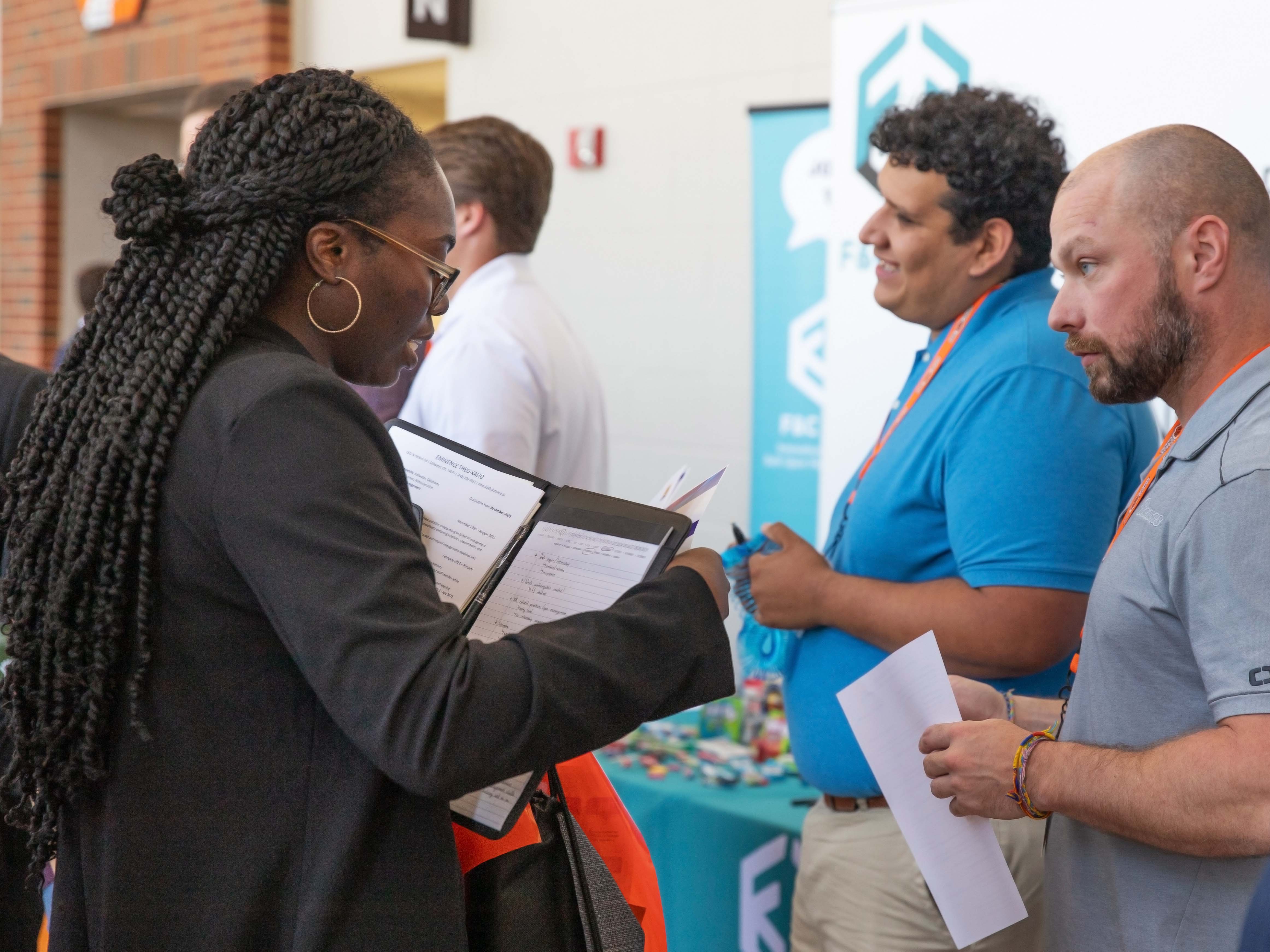 Student at career fair speaking with employer