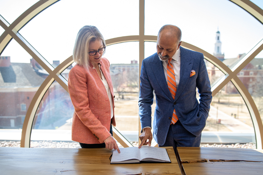 woman and man looking at a book