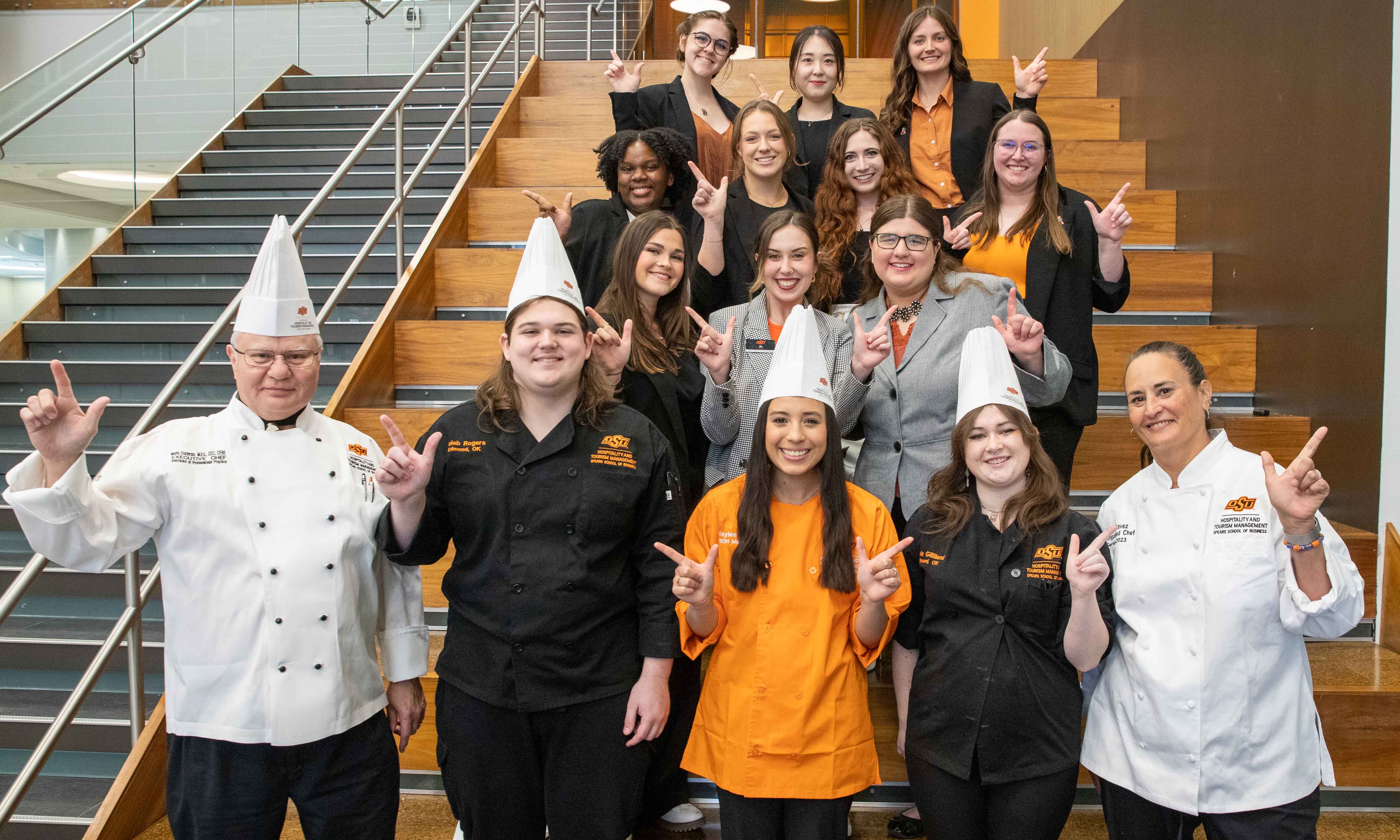 Student workers smiling and posing with Chef Mica Chavez in 2023.