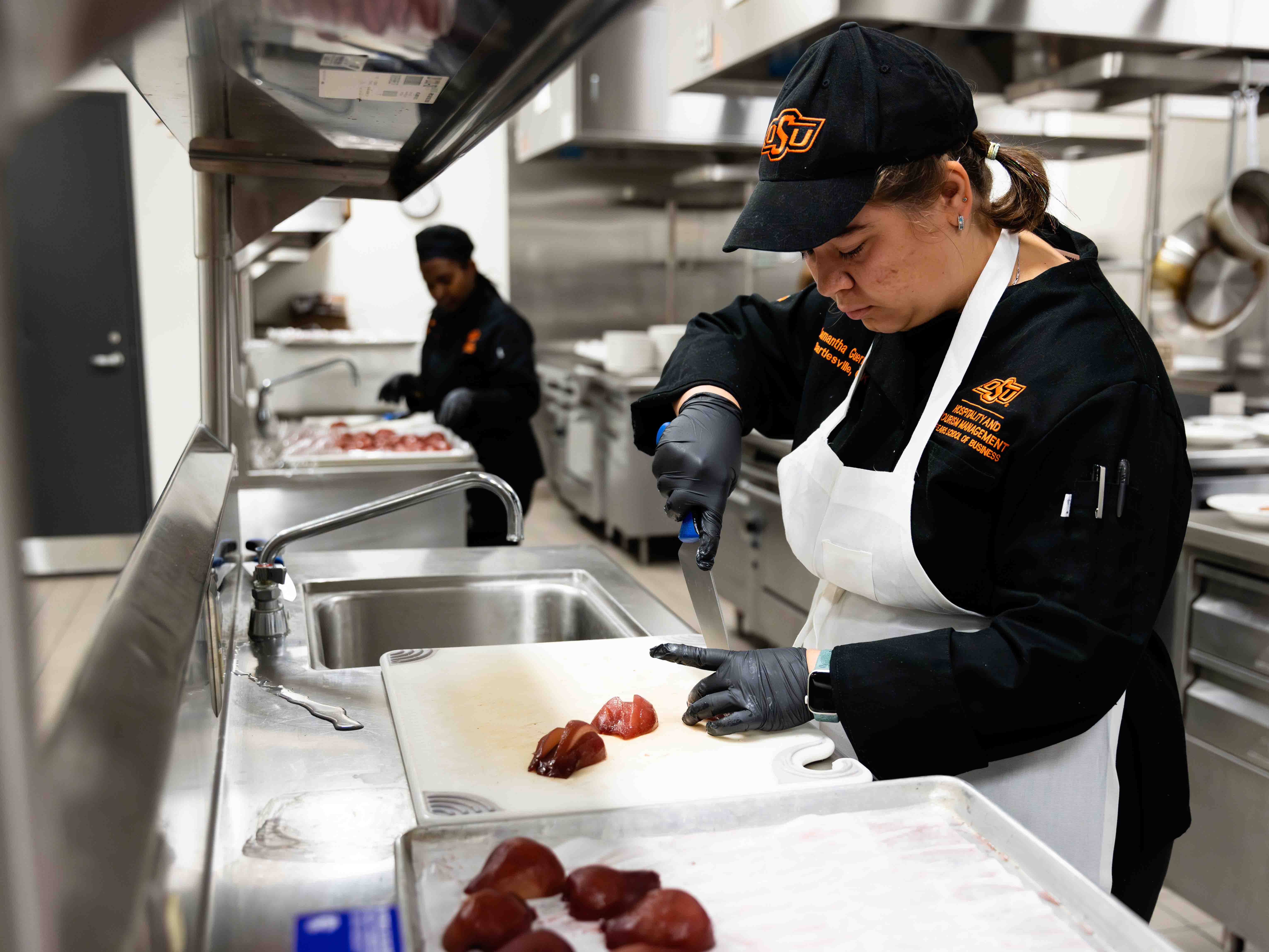 Student preparing food for Chef Mark Wright's lunch in 2024