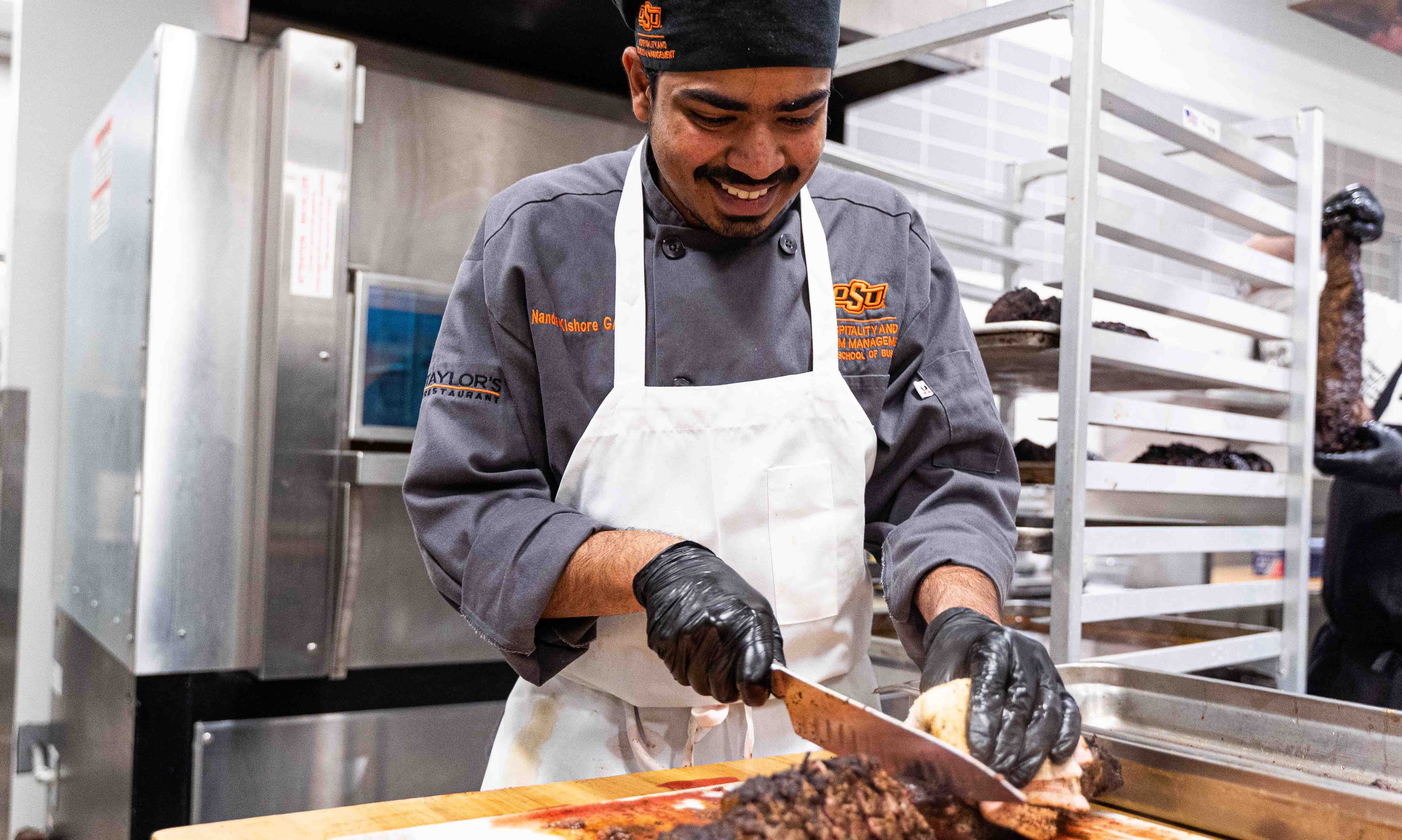 A student prepares the meal for the 2023 event with Chef Mica Chavez.