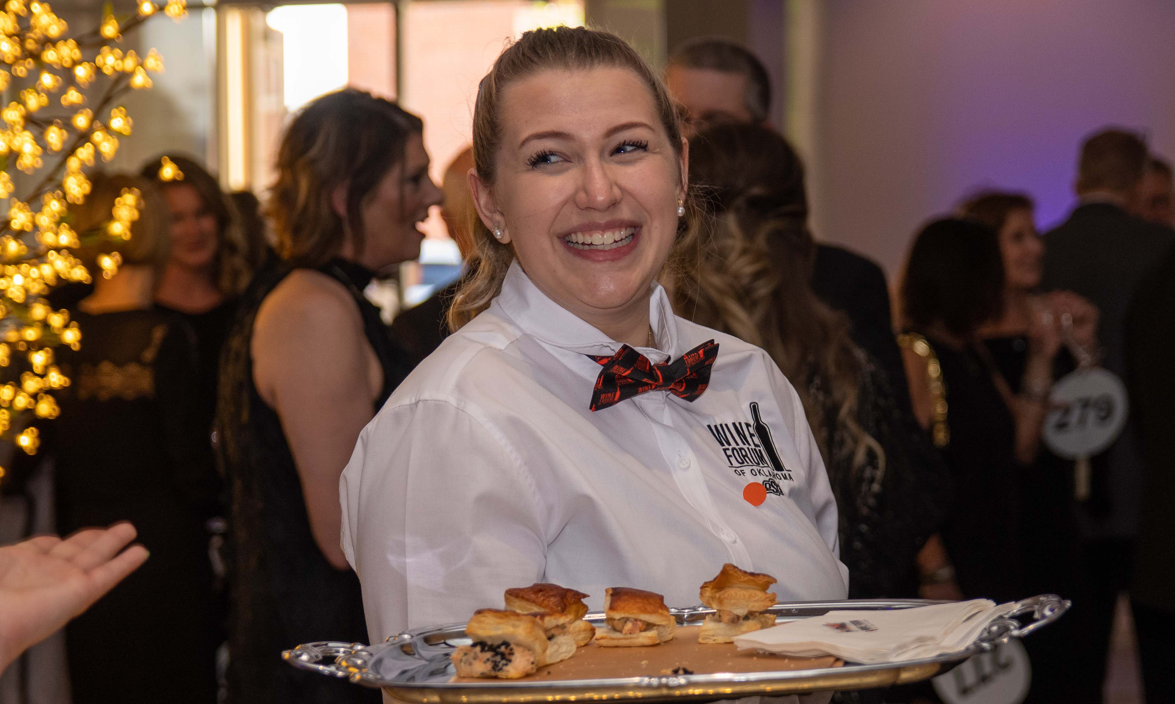 Student smiling with a serving tray.