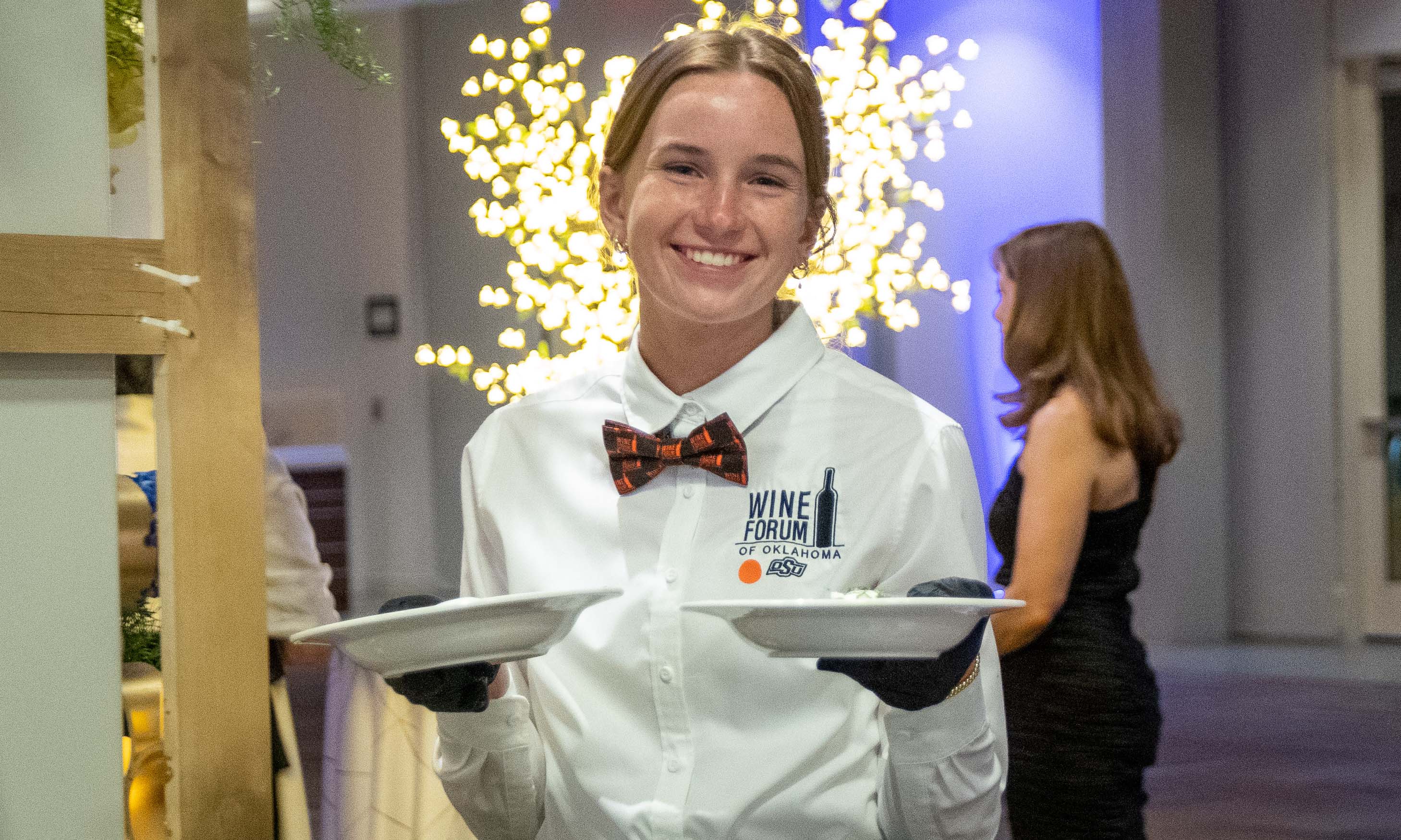 student worker holding two bowls.
