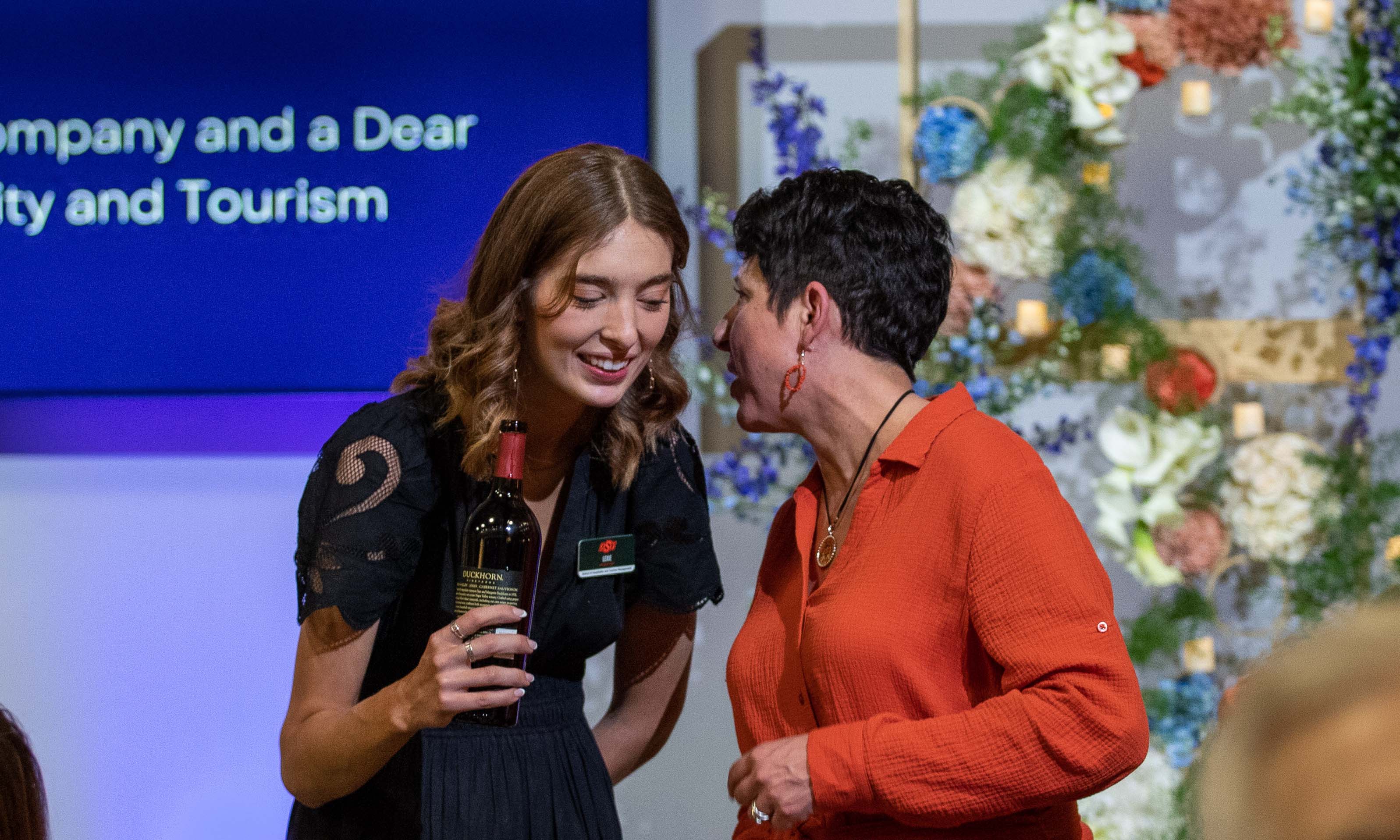 donor whispering to student worker.