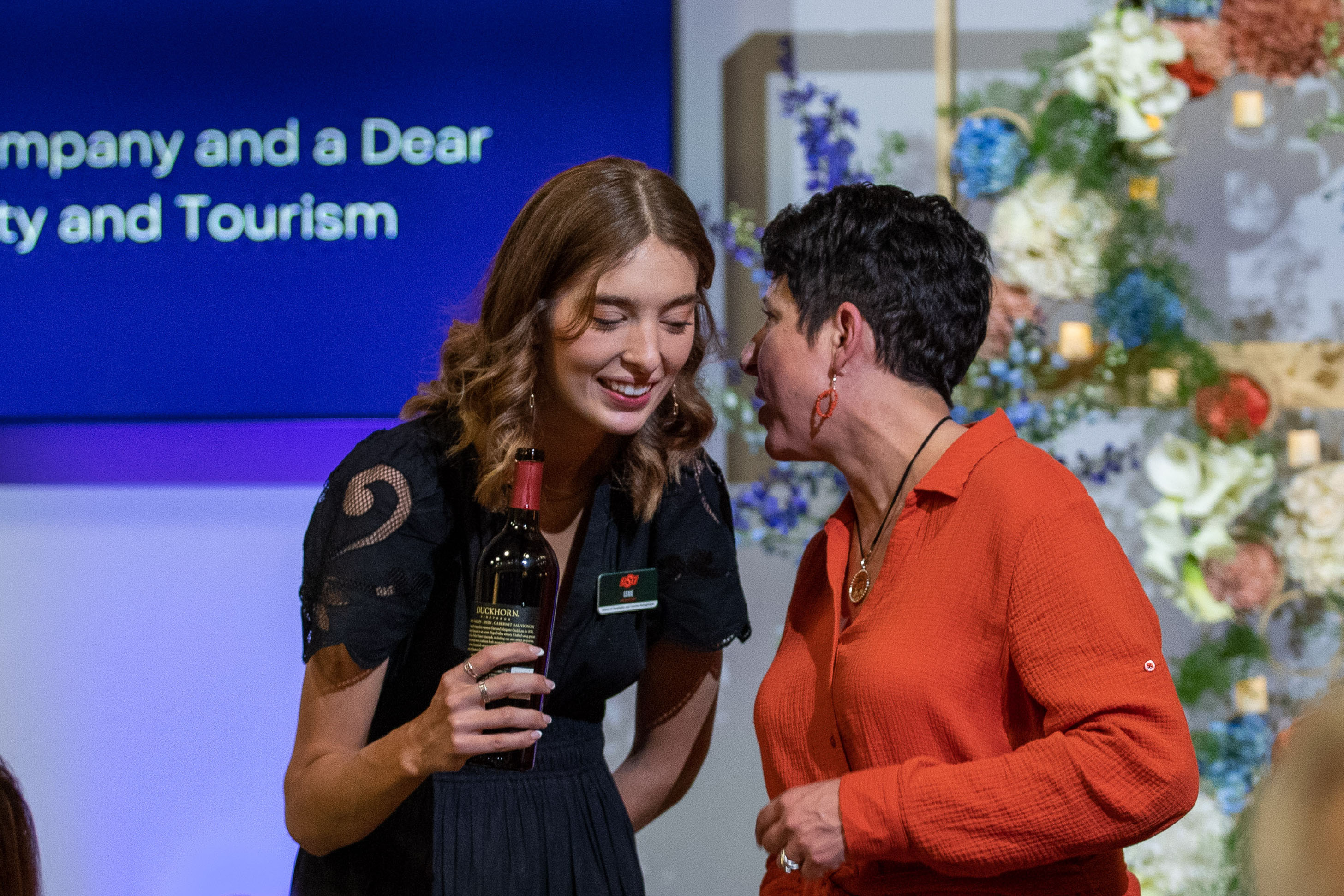 Patron talking in a whisper to a student worker.