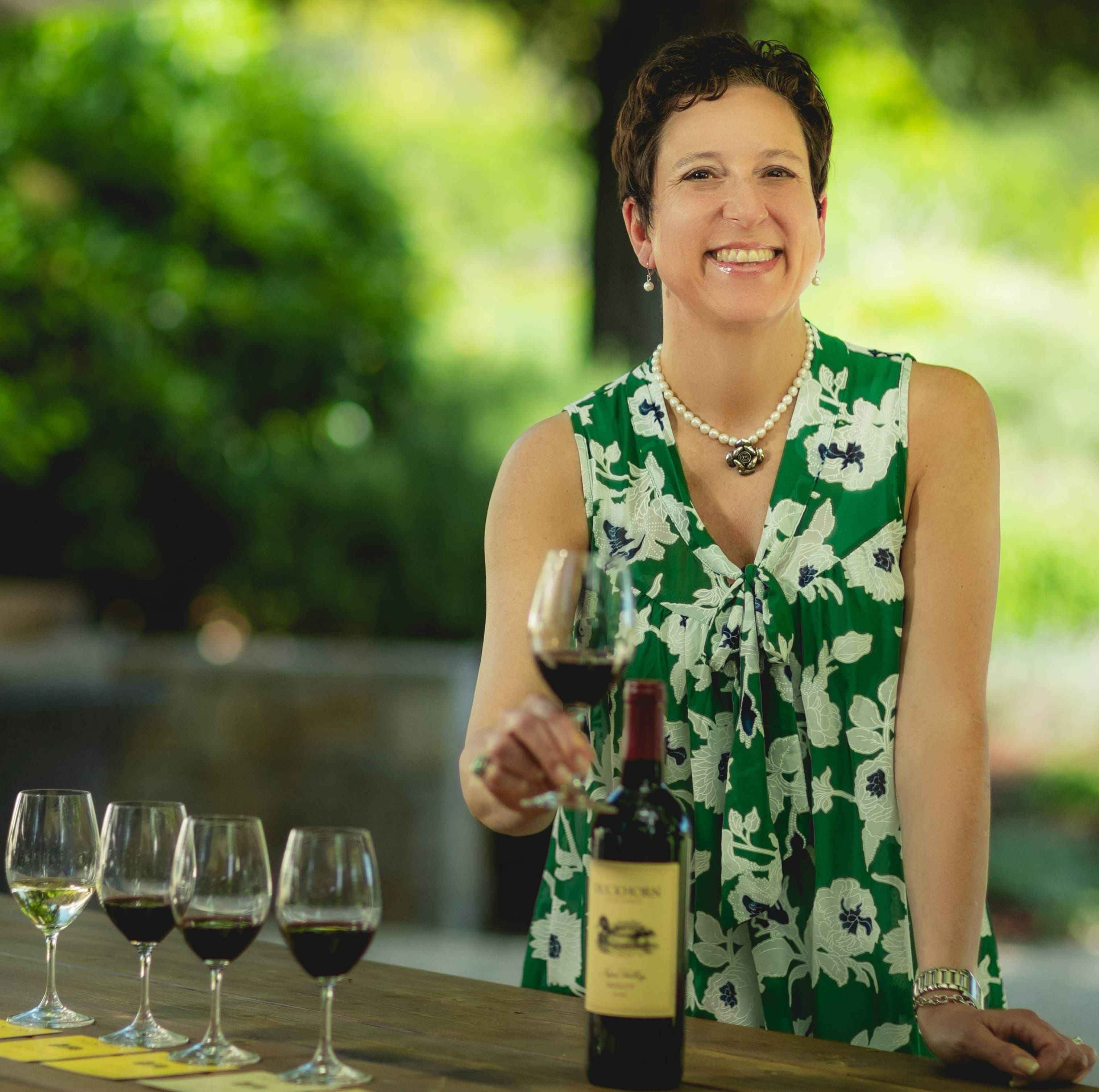 Kay Malaske holding a glass of wine