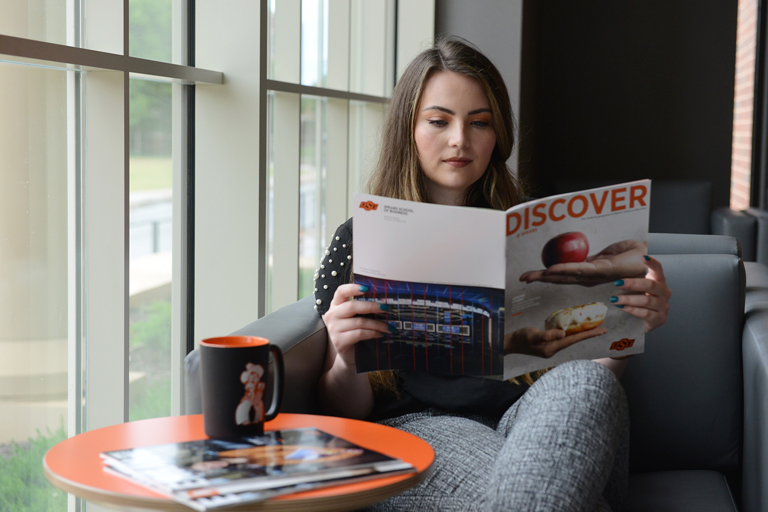 Young professional reading magazine