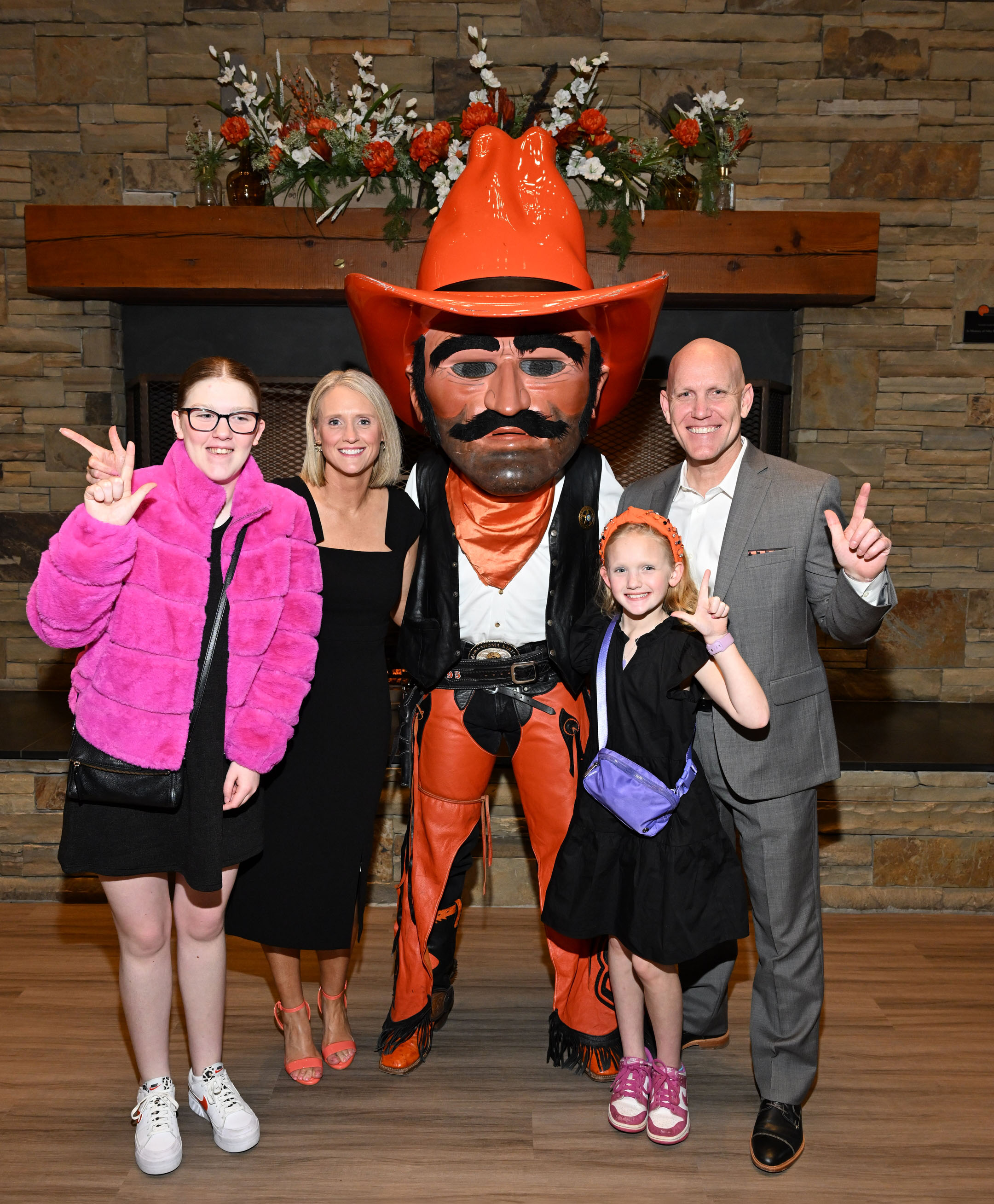 Alumni and family standing with Pistol Pete