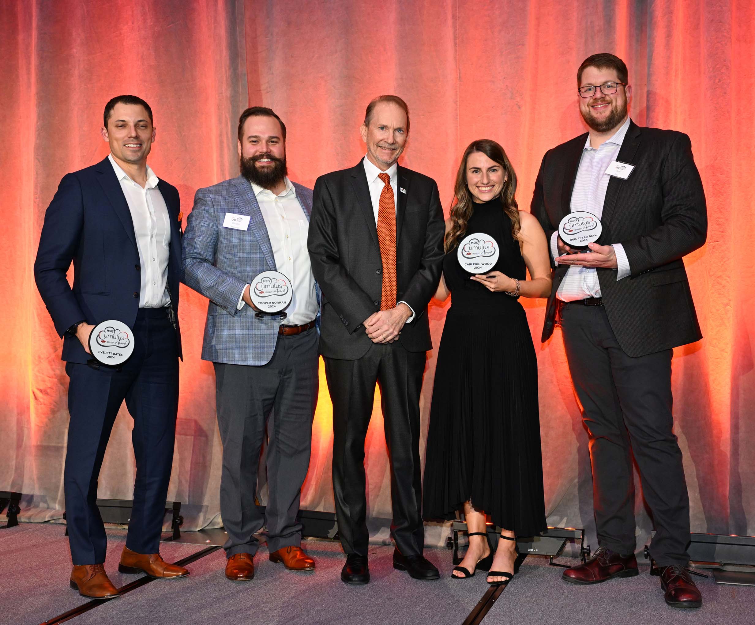 Cumulus award winners standing on stage holding awards.
