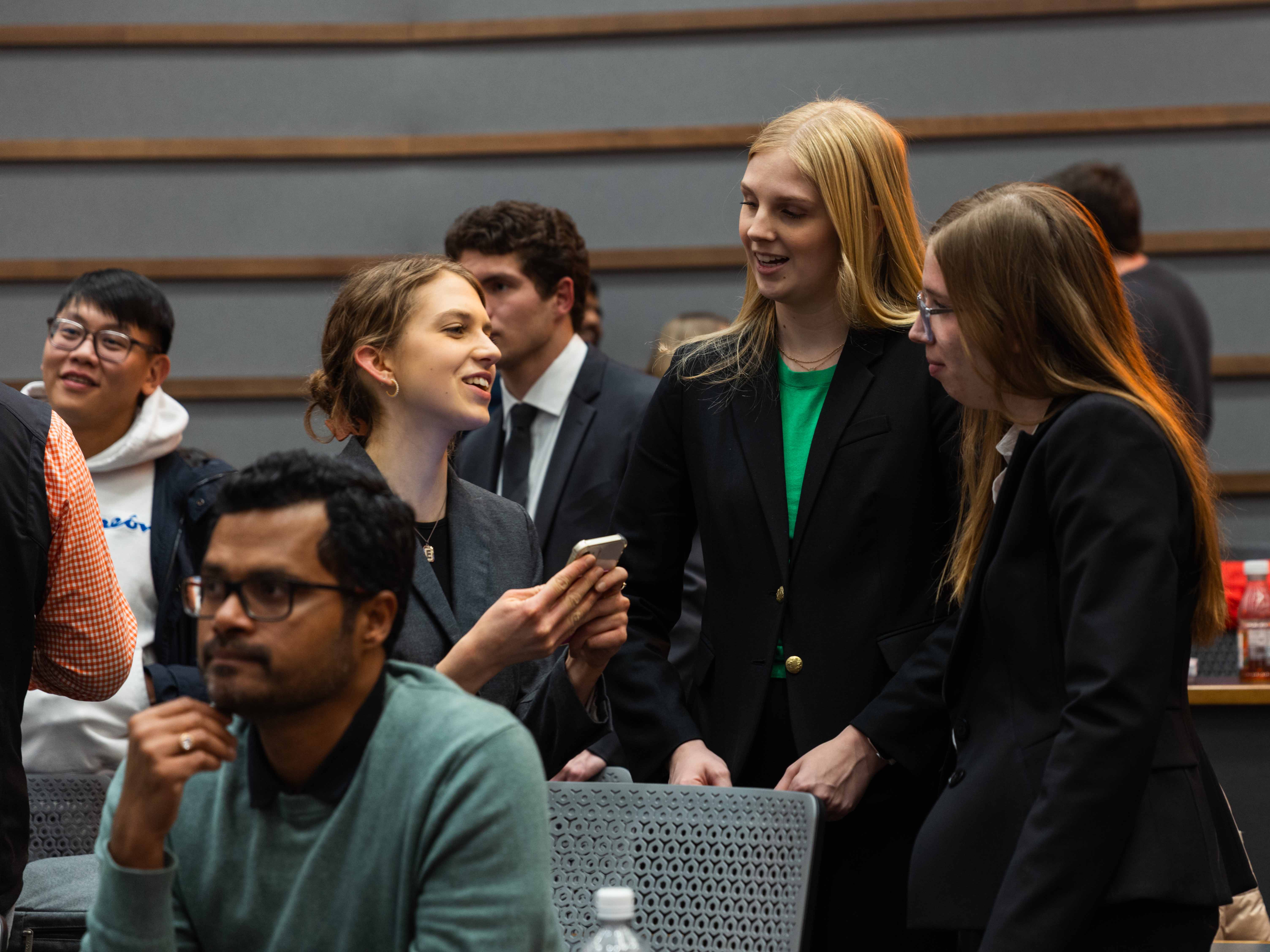 Students smiling and talking at Datathon competition