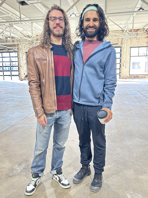 Two people standing inside a building.