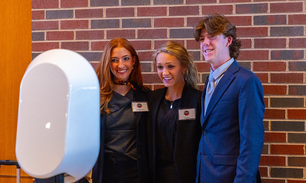 Three Spears Business students pose with a photo machine prior to the Cowboy100 Gala.