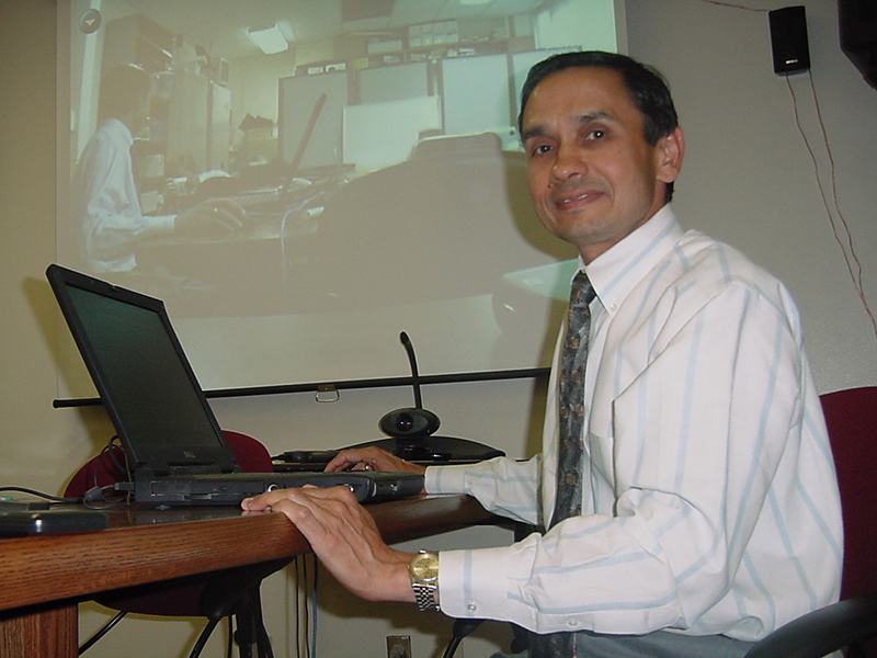 A man behind a laptop A man behind a laptop